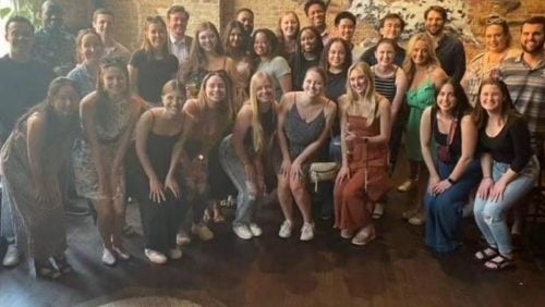 Large group of students smiling at social gathering