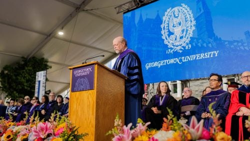 Dean William Treanor speaking at Commencement 2025 from the podium.