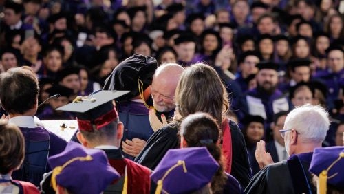 Dean Treanor offering an embrace at Commencement 2025