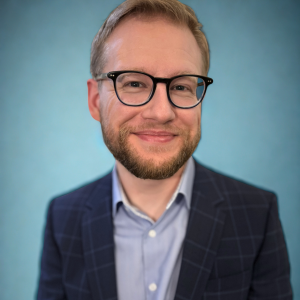 Wesley Wood headshot, short blonde hair, glasses, and a beard